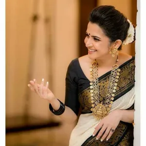 ππ» *Traditional Kanchipuram at its finest and most classic!*
π€© *Bold and beautiful, this Kanchipuram silk brocade white and golden checks saree is all about impactful presence. Its gold zari patto brocade body exudes a charm well-supported by the contrast black boarder pallu and border. Both carry floral vines, had tree , and brocade as a beautiful ode to the traditional art.*